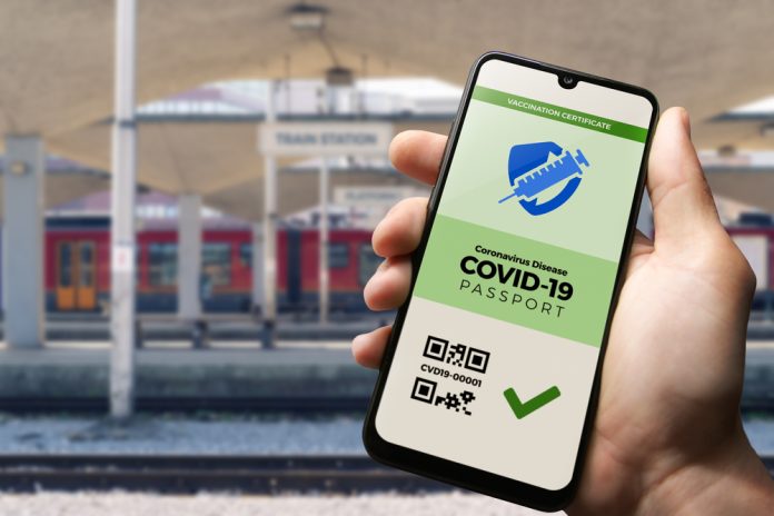 Vaccination,Passport,For,Covid-19,Displayed,On,Smartphone,Held,In,Male's