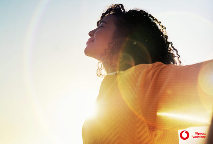 Freedom, flare and sky with a woman outdoor at sunset during summer to relax with fresh air and sunshine. Happy, carefree and mockup with a young female feeling relaxed outside in the morning